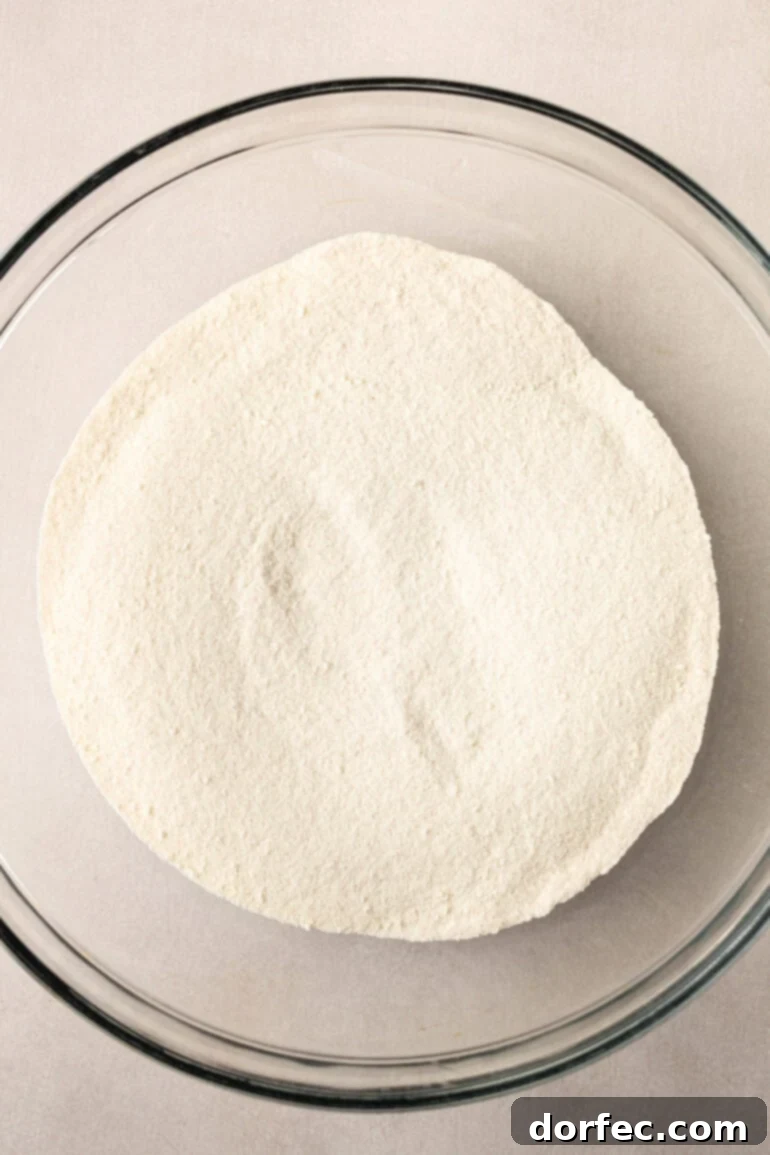 A close-up photo showing the fine texture of the Snowman Soup powder, ready for mixing, highlighting its light and airy quality.