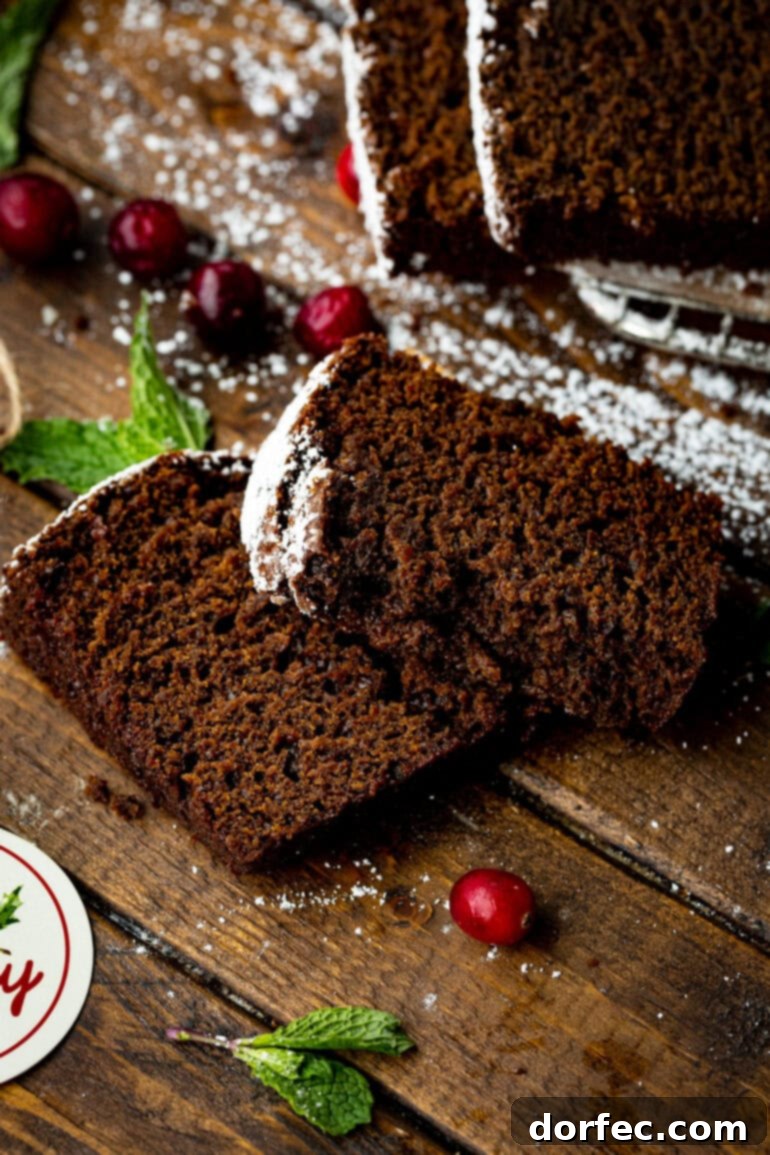 Classic Gingerbread Loaf 9 A photo showcasing two generously thick slices of a perfectly moist gingerbread loaf, highlighting its tender texture.
