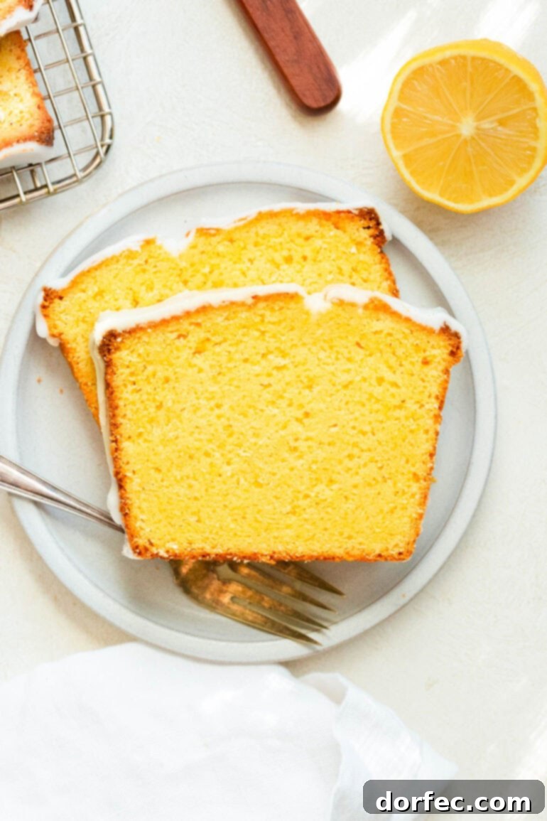 Zesty Lemon Glazed Loaf 7 Two generous slices of glazed lemon pound cake, artfully arranged to showcase its moist crumb and glistening lemon glaze.