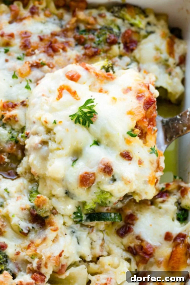 A photo of a serving of golden baked lasagna being lifted out of a pan full of lasagna, showcasing its cheesy, layered perfection.