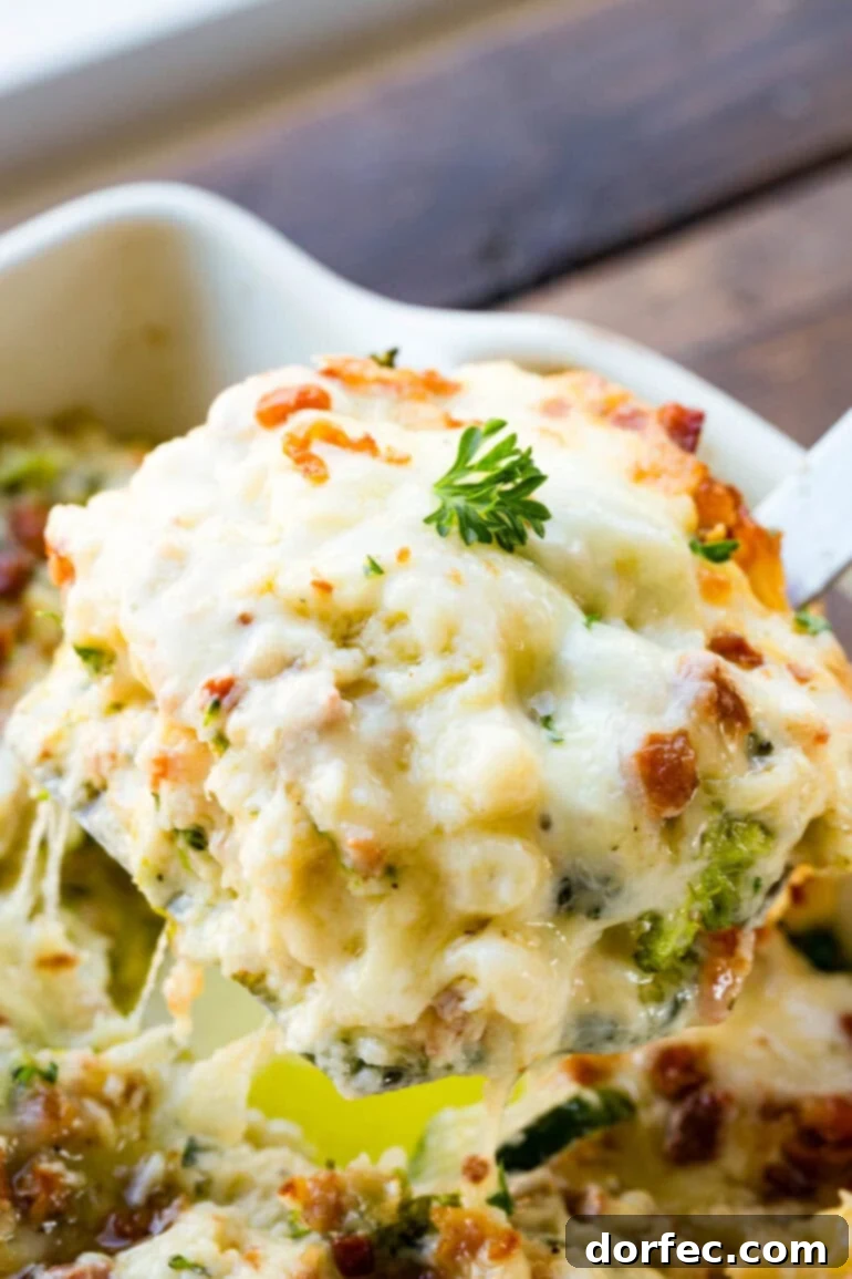 A photo of a scoop of creamy golden baked vegetable white lasagna being removed from a full pan, showcasing its rich, layered interior.