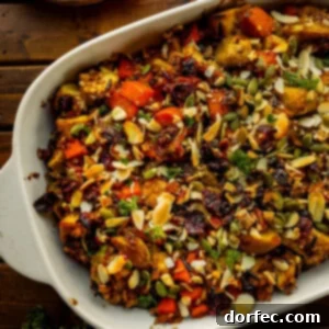 a photo of a white baking dish full of a colorful harvest chicken casserole