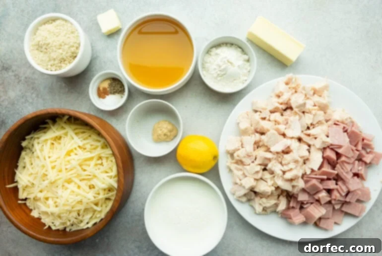 A vibrant flat lay photo showcasing all the fresh ingredients for Chicken Cordon Bleu Casserole, including raw chopped chicken, Swiss cheese, Dijon mustard, milk, and various spices.
