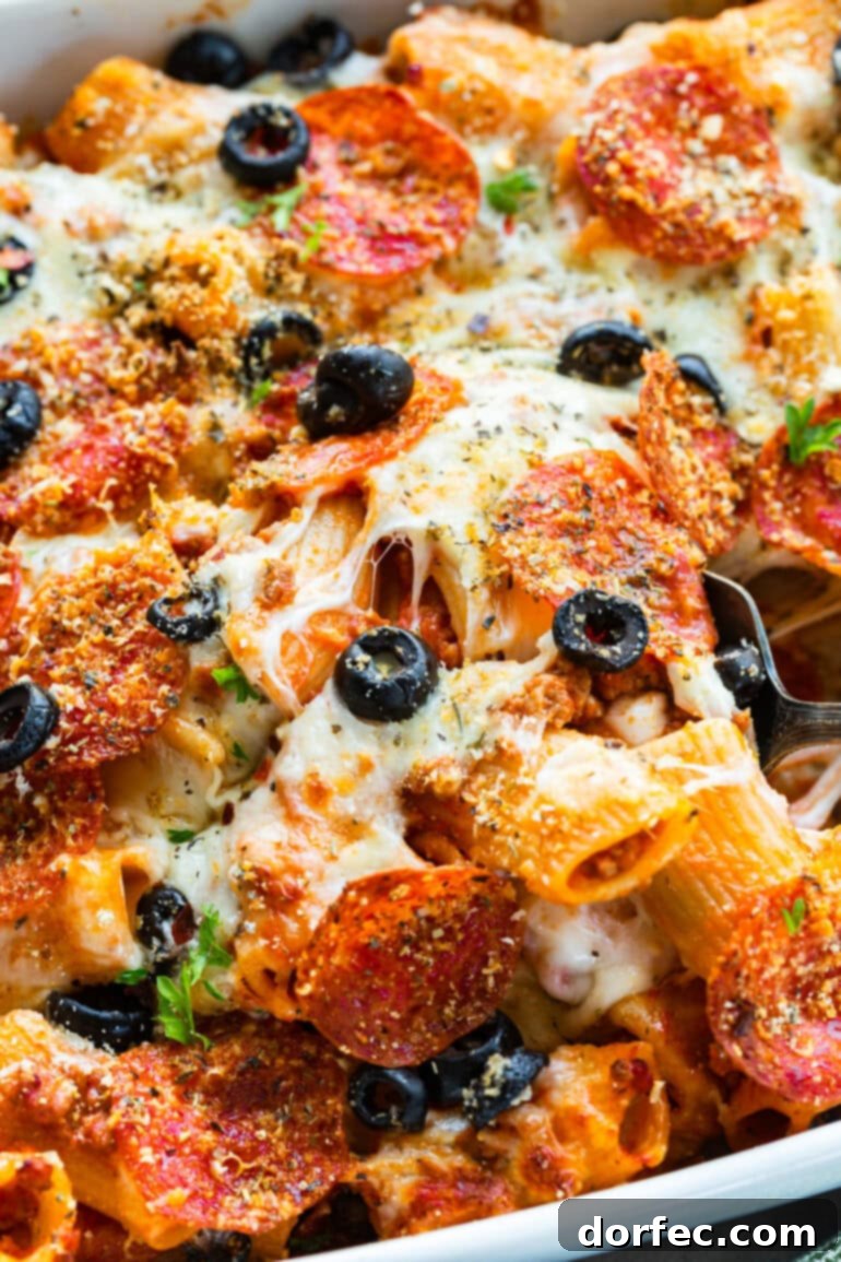 a photo of a scoop of pizza casserole being removed from a casserole dish