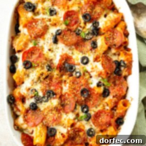 a photo of a 9x13 casserole dish filled with baked pizza pasta casserole