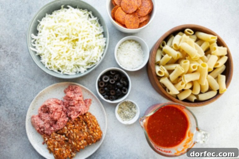a photo of all the ingredients for pizza pasta casserole in separate small bowls including mozzarella cheese, pizza sauce, olives, pepperoni, sausage and ground beef