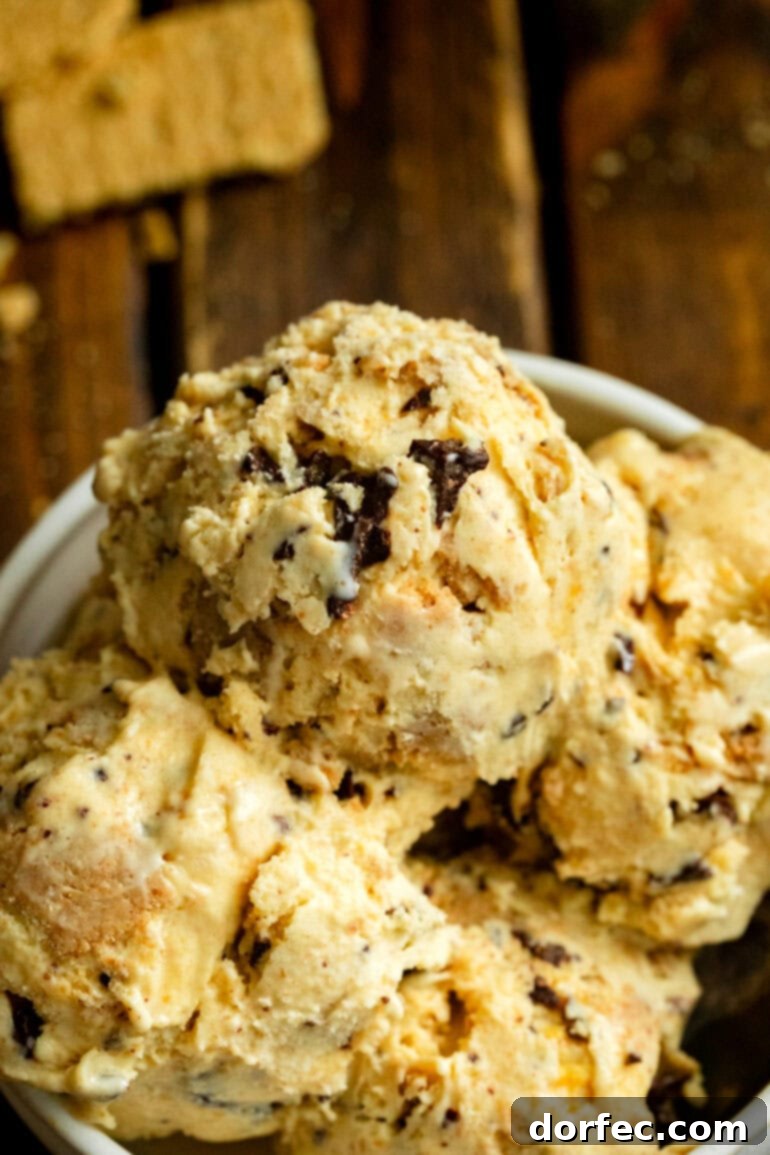 A large bowl filled with abundant scoops of Graham Canyon ice cream, showcasing its creamy texture and generous chocolate-covered honeycomb bits.
