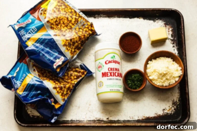Sheet Pan Oven Elote 3 a photo of all the ingredients for creamy mexican street corn including bags of frozen corn, a bottle of mexican crema, chili powder, cotija cheese, etc