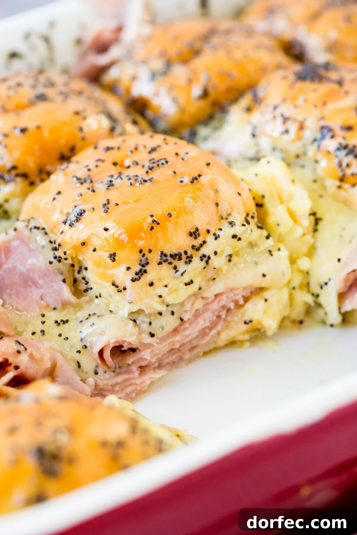 Delicious ham and cheese sliders with a zesty poppy seed dressing, perfect for using up leftover holiday ham.