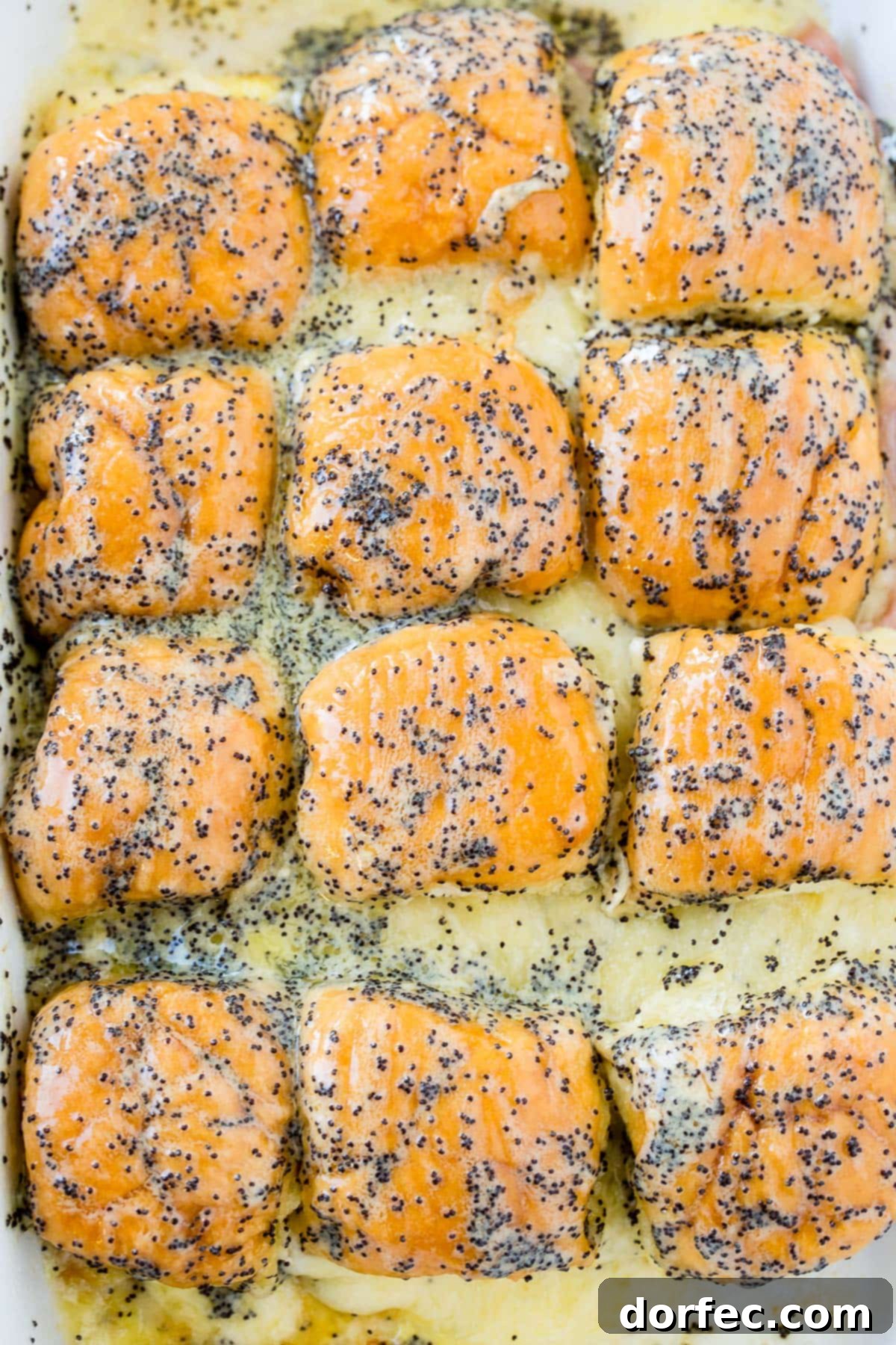 Search no further for the best ham and cheese sliders recipe with poppy seed dressing, adapted from The Girl Who Ate Everything!