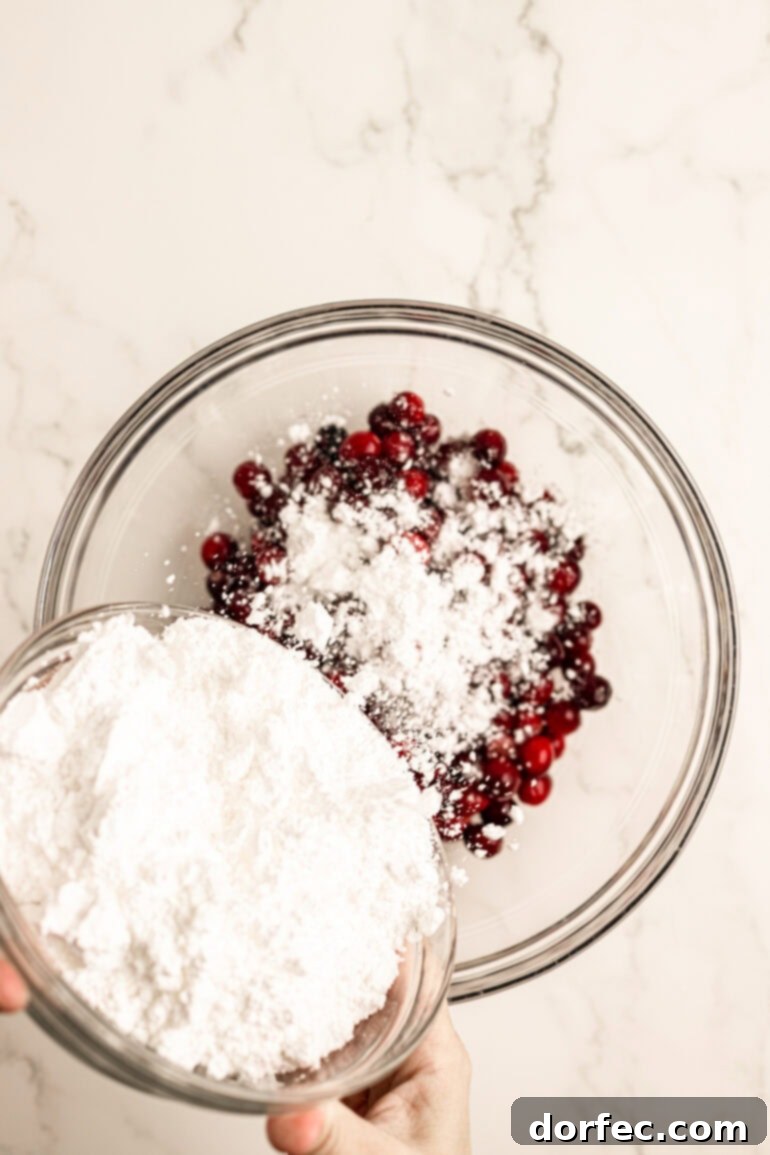 Glittering Sweet Tart Cranberries 6 Step-by-step image of cranberries being coated with powdered sugar.
