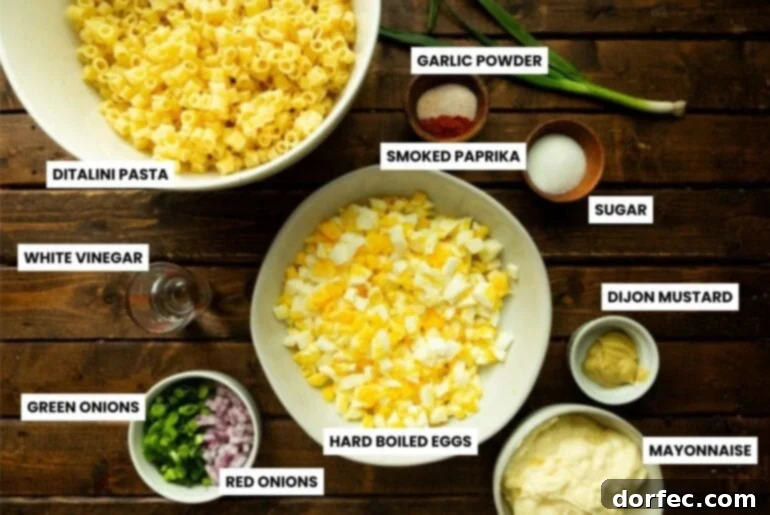A vibrant flat lay photo showcasing all the fresh ingredients needed for a delicious deviled egg pasta salad, neatly arranged in small bowls on a rustic wooden table.