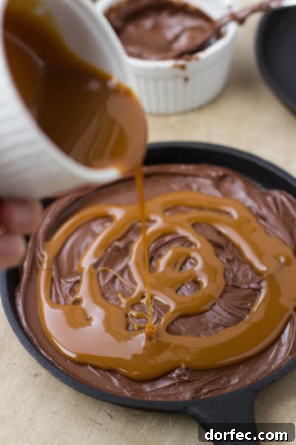 Ultimate Millionaire Skillet Cookie 2 The beginning of a Millionaire Skookie: a layer of Nutella spread across the bottom of a skookie pan.