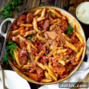 A vibrant and appetizing close-up of Skillet Italian Sausage and Peppers with Whole-Wheat Penne, garnished and ready to be served.
