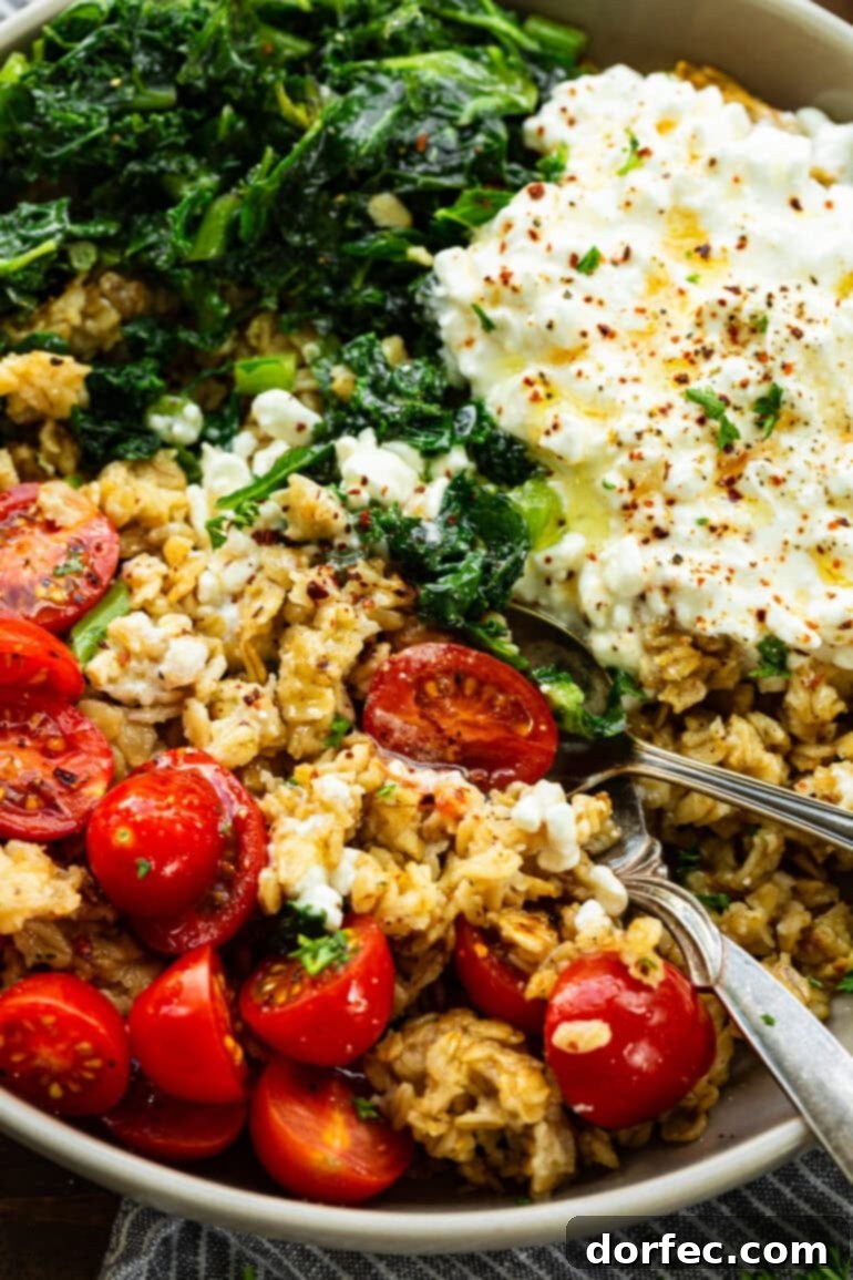 Speedy Savory Protein Oats with Cottage Cheese 6 A beautifully presented savory oats breakfast bowl, featuring crispy golden oats, vibrant tomatoes, creamy cottage cheese, fresh kale, and a sprinkle of seasonings for an appetizing start to the day.