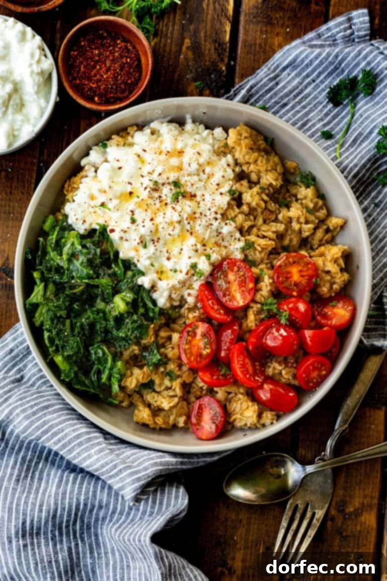 Speedy Savory Protein Oats with Cottage Cheese 8 A high-protein savory oatmeal breakfast bowl featuring golden crispy oats, creamy cottage cheese, vibrant tomatoes, and fresh kale, offering a delicious and nutritious start to the day.