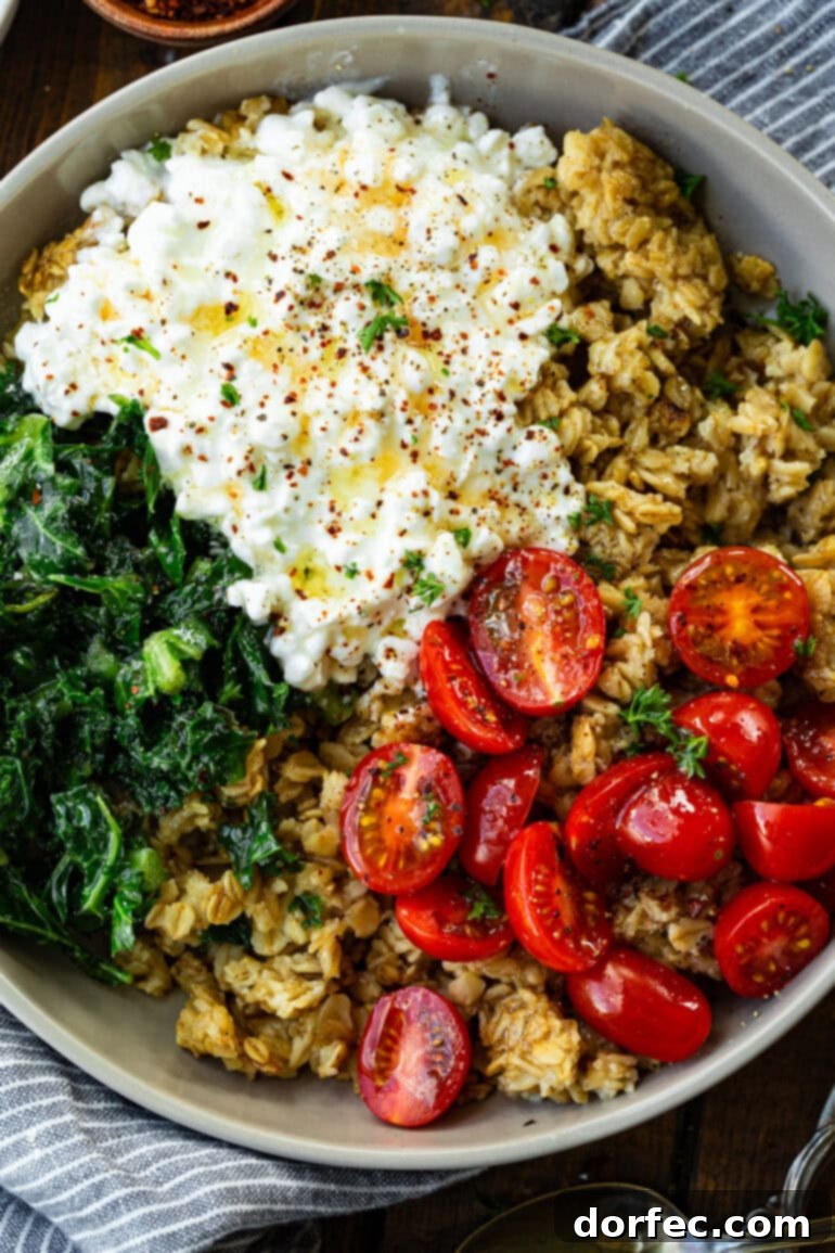 Speedy Savory Protein Oats with Cottage Cheese 9 An inviting overhead view of a savory oatmeal and cottage cheese breakfast bowl, garnished with fresh tomatoes and kale, ready to be devoured.