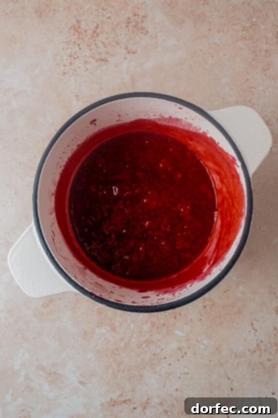Cooking raspberries with cornstarch, sugar, and water for the sauce.