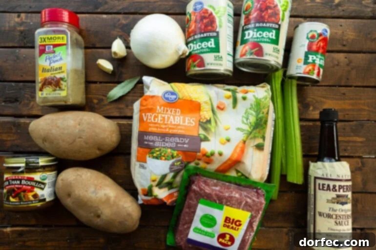 Simple & Satisfying Ground Beef Vegetable Soup 4 All the vibrant ingredients for ground beef vegetable soup laid out on a countertop, including fresh ground beef, whole russet potatoes, crisp celery stalks, a bag of frozen mixed vegetables, a yellow onion, fresh garlic cloves, and a can of diced tomatoes.