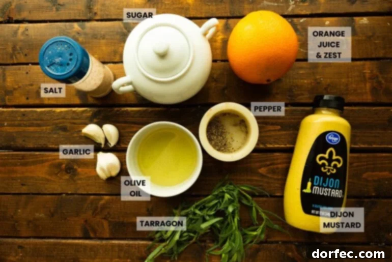 A vibrant flat lay of fresh ingredients including garlic cloves, olive oil, pepper, Dijon mustard, fresh tarragon, and a ripe orange, all arranged on a rustic wooden surface, highlighting the core components of the citrus marinade.
