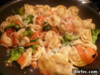 Light Velvety Pesto Tortellini 5 Tuscan tortellini dish with vegetables.