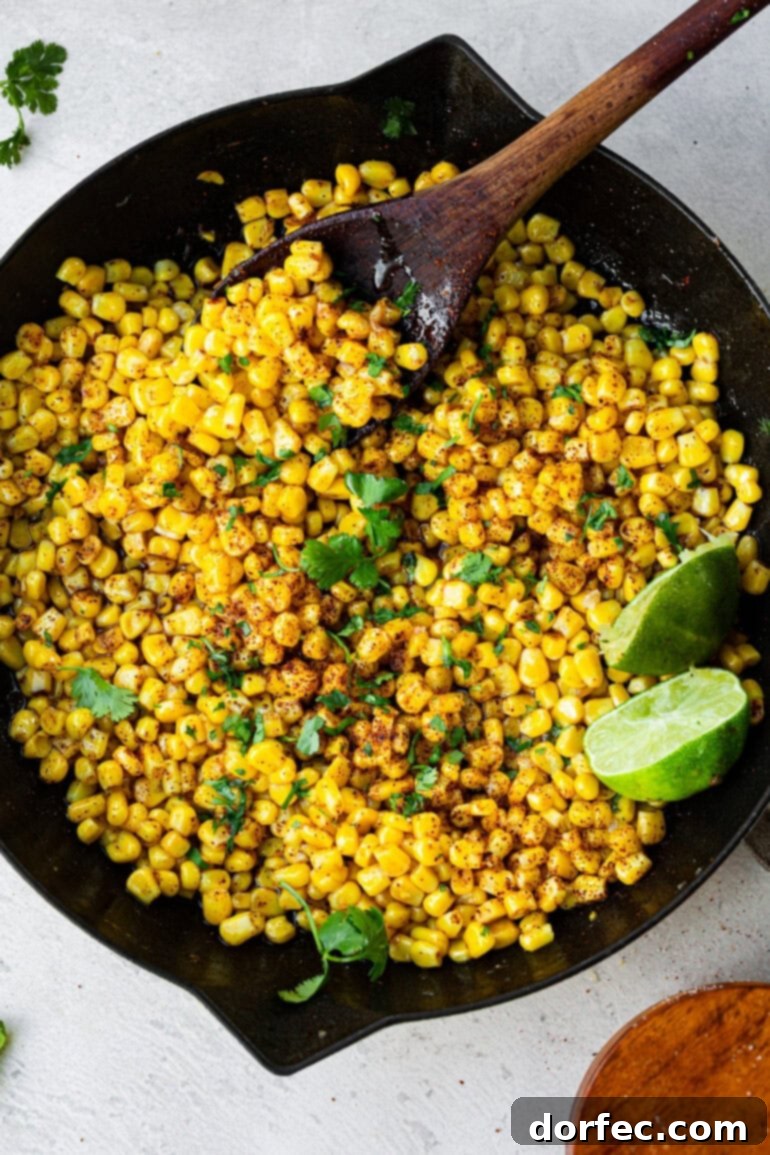 Quick Honey Lime Skillet Corn 2 Cooked corn coated in glossy honey butter sauce, speckled with chili powder and flecks of lime zest, served in a rustic bowl.