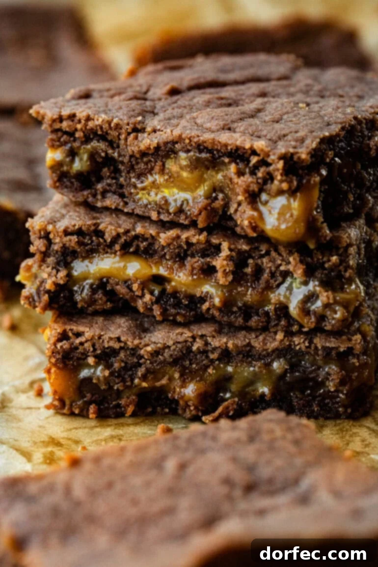 Simple Homemade Caramel Brownies 2 A stack of brownies with each with a gooey layer of caramel.