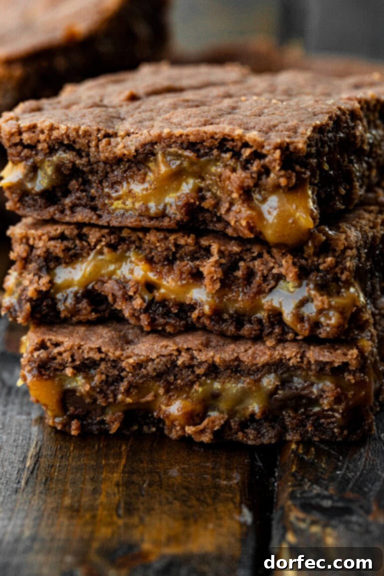 Simple Homemade Caramel Brownies 4 a stack of three chocolatey brownies with a buttery caramel layer