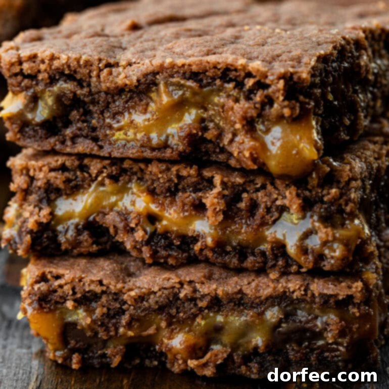 Simple Homemade Caramel Brownies 5 A stack of 3 layered brownies with a center layer of gooey caramel.