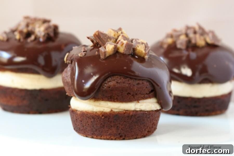 Chocolate Peanut Butter Cupcakes - are you drooling yet? Reese's peanut butter cups, chocolate ganache A beautifully arranged serving of Chocolate Peanut Butter Cupcakes on a rustic wooden board.
