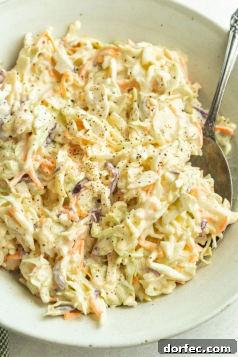 Crafting Your Perfect Homemade Coleslaw 2 A heaping bowl of creamy homemade coleslaw made with crisp green cabbage, shredded carrots, and tangy mayo dressing.