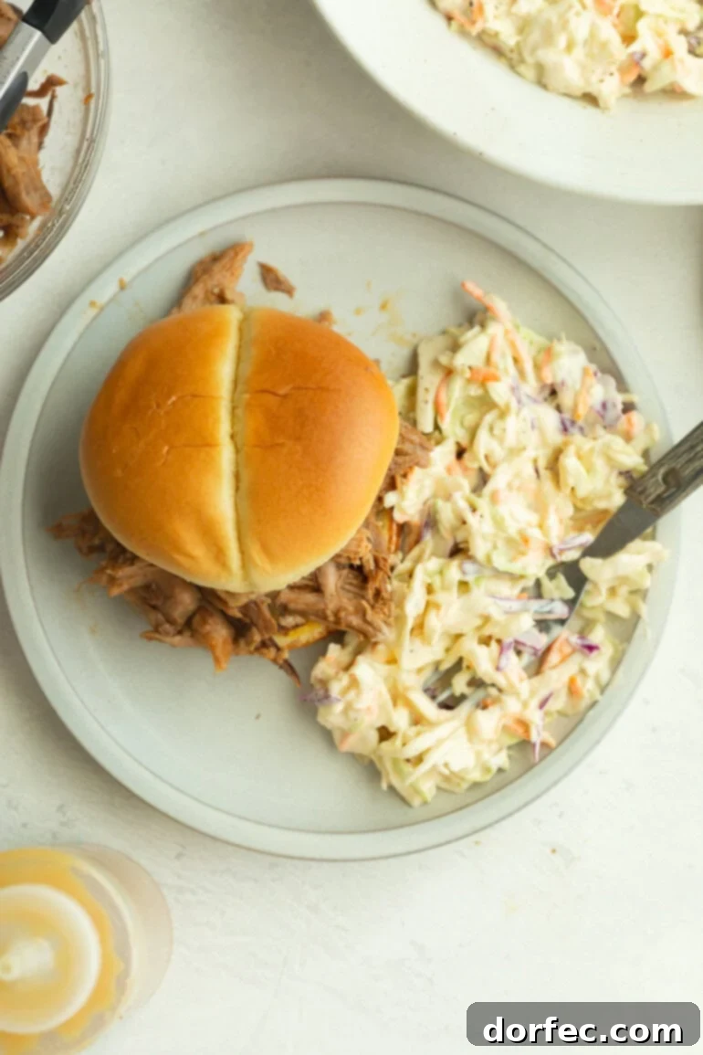 Crafting Your Perfect Homemade Coleslaw 3 a bun with pulled pork with creamy summer slaw made with shredded green cabbage and carrots, dressed in a smooth, flavorful mixture.