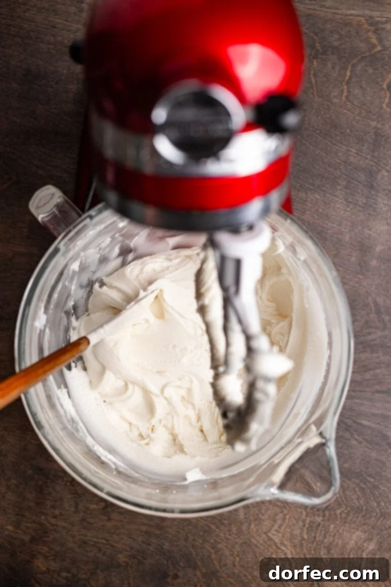 Mixing peppermint topping ingredients in a stand mixer.