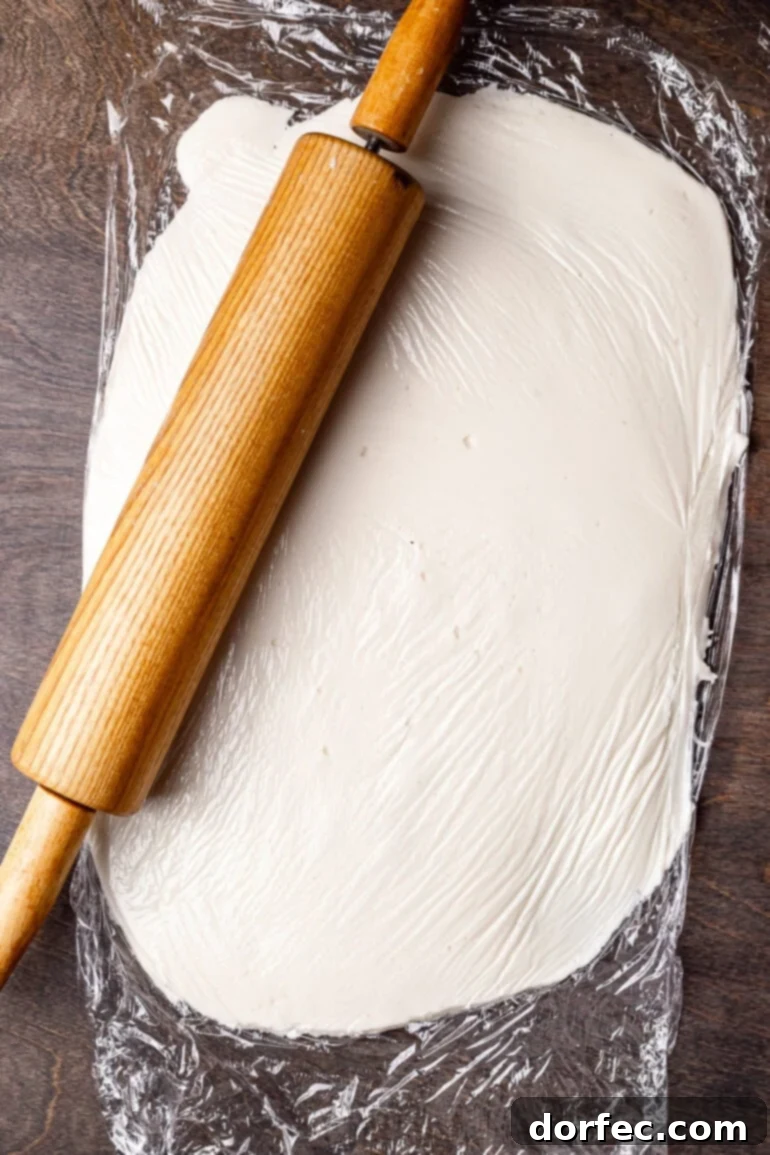 Pressing peppermint mixture into a disc on plastic wrap.