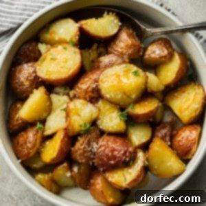 Perfectly Roasted Red Potatoes 7 A beautifully presented serving of golden, crispy roasted red potatoes, glistening with honey butter Dijon sauce in a simple white bowl.