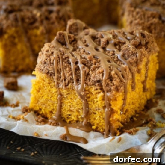 A slice of Pumpkin Coffee Cake with a generous cinnamon crumb topping, ideal for breakfast or dessert