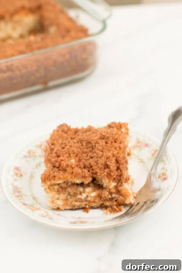 Homemade Banana Coffee Cake Golden-brown streusel topping on a delicious banana coffee cake, ready to be served.