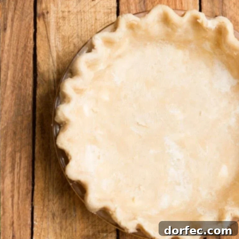 The Best Carrian Pies 5 Mom's Fail Proof Pie Crust rolled out on a counter.