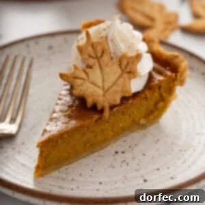A perfectly baked slice of homemade pumpkin pie, reflecting its golden color and creamy texture.