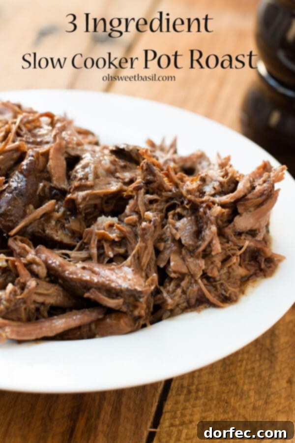 our favorite slow cooker pot roast recipe! ohsweetbasil.com crockpot, insta pot, pressure cooker A close-up of tender, shredded slow cooker pot roast, showcasing its rich brown color and succulent texture.