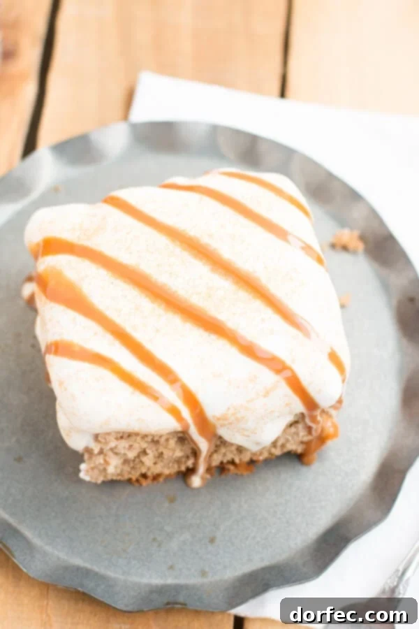 Caramel Spice Poke Cake with Fresh Whipped Cream and Caramel Drizzle Close-up of Caramel Spice Poke Cake topped with fluffy homemade whipped cream