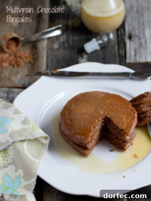 Luscious White Chocolate Blueberry Pancakes 4 Healthy multigrain chocolate pancakes served on a white plate