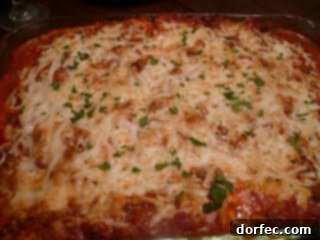 A portion of hearty meat lasagna, showing layers of pasta, meat sauce, and cheese