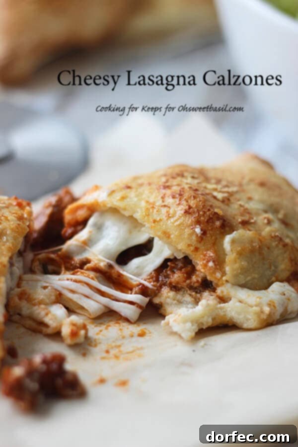 Two cheesy lasagna calzones, golden brown and filled with savory goodness