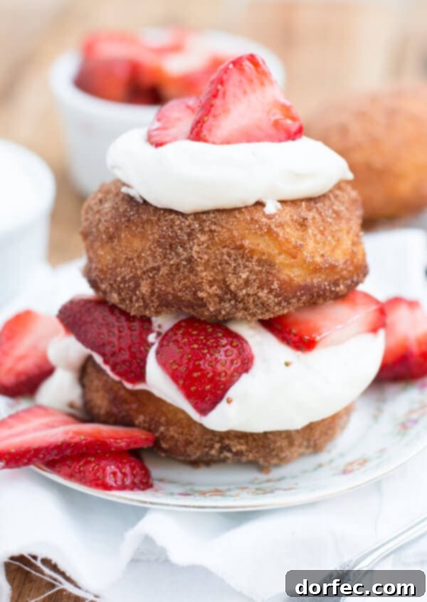 Closeup of fluffy whipped cream, ready to be paired with deep fried strawberry shortcakes