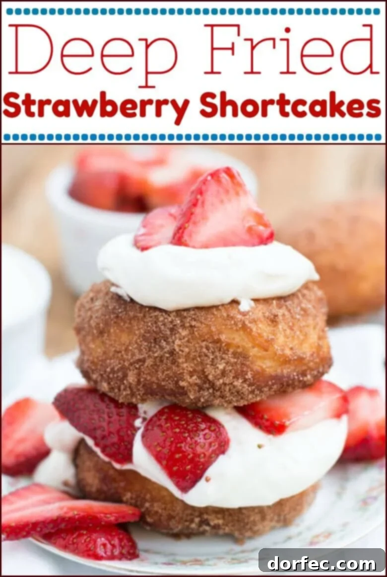 A beautifully plated deep fried strawberry shortcake, garnished with fresh berries and a hint of mint