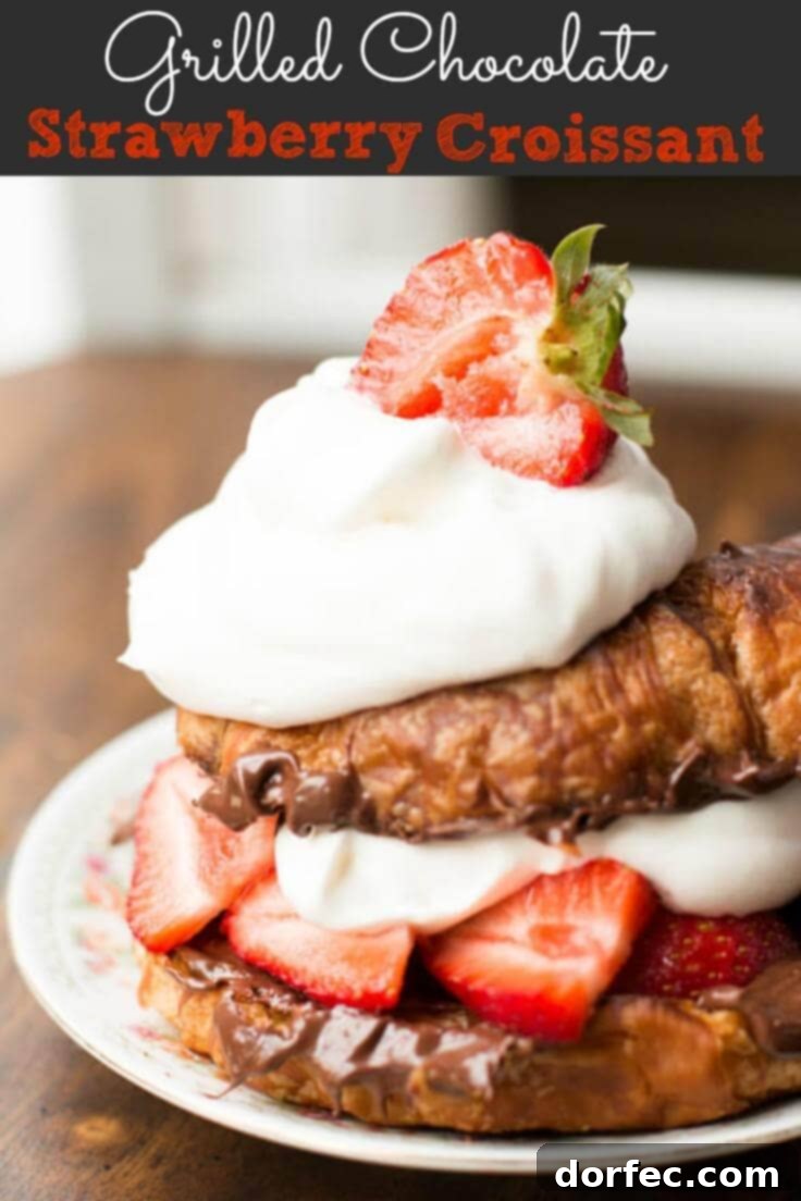 A beautifully composed shot of a single grilled croissant, bursting with hazelnut spread and fresh strawberries, topped with whipped cream, ready for a close-up.