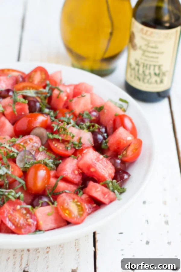 The BEST watermelon salad recipe with fresh mint and a light dressing, a perfect refreshing summer side dish from OhSweetBasil.com