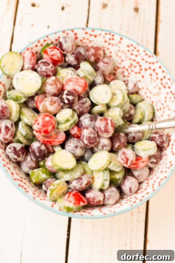 Refreshing Cucumber Grape Salad with Strawberry Poppyseed Dressing, a unique and sweet summer side dish from OhSweetBasil.com