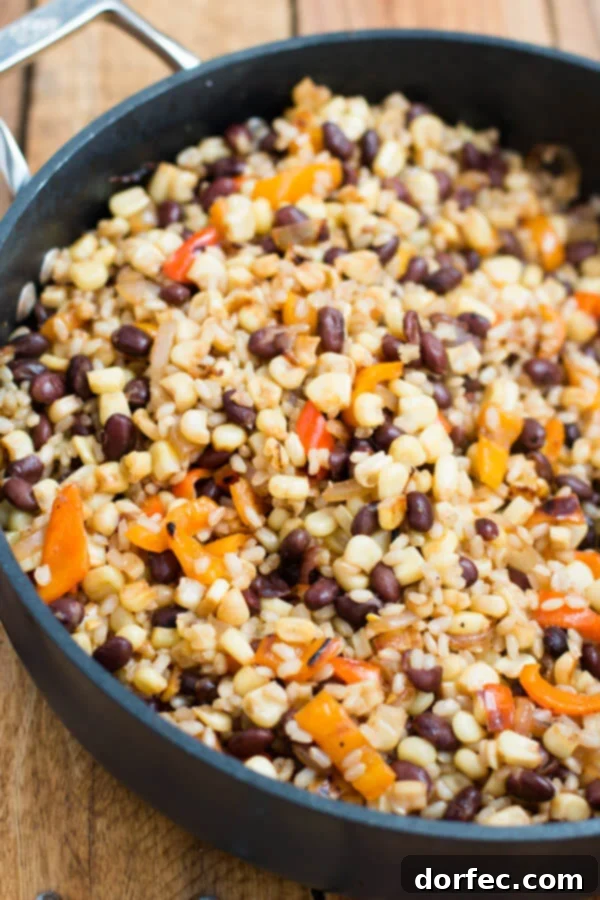 Hearty Grilled Corn Salad with Black Beans and Rice, a satisfying and flavorful summer dish from OhSweetBasil.com